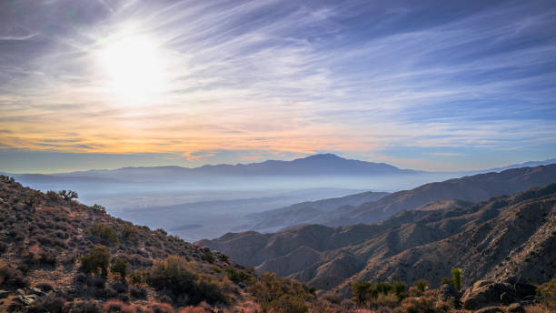 istock Keys View summit at sunset, a high viewpoint with Indio Hills, Mt San Jacinto, and hazy clouds in Southern California 1453479115
