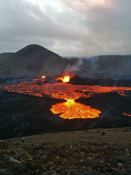 istock Volcano with lava pouring into the air from a crater 1453479926