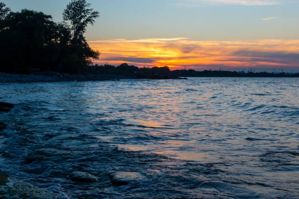 istock Beautiful bright sunset sky over a blue lake 1453482980