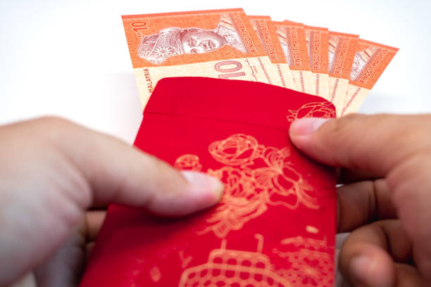 istock Chinese new year festival red envelope with Ringgit Malaysia note 1453484159