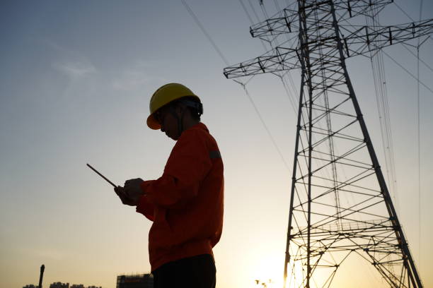 istock Background of engineers at power site at dusk 1453486174