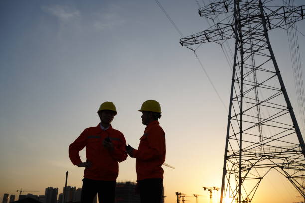 istock Silhouettes of engineers and workers at power plant 1453486188