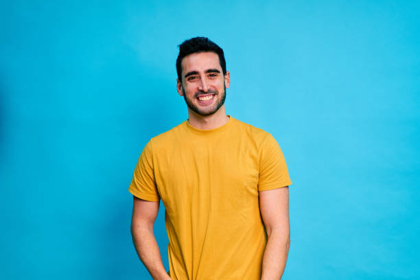 istock Cheerful young man smiling and looking at camera 1453494630