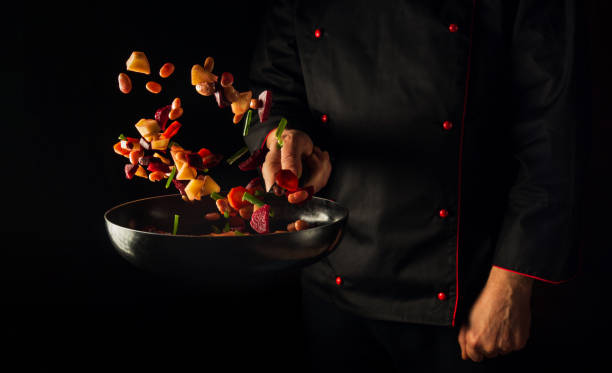暗い背景にシェフの手が野菜を調理し、コピー用スペース。食べ物のコンセプト。ホテルの野菜メニュー - leaf vegetable freshness vegetable market ストックフォトと画像