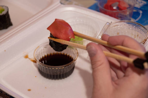 set with sushi from the store in plastic packaging on the table for dinner, there is sushi at the table at home, plastic disposable sushi packaging