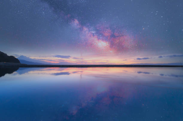 istock Beautiful night view with milkyway over the seasecape. 1453502330