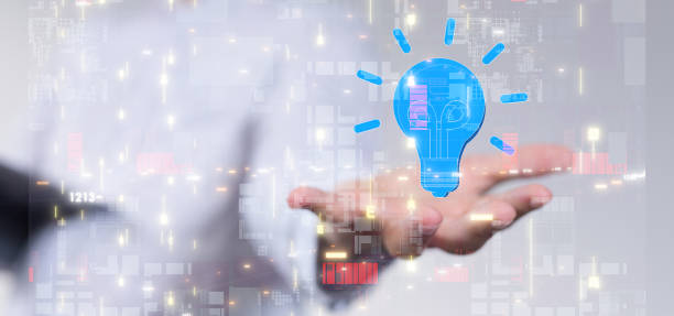 istock Hand reaching out to an illustrated lightbulb with code particles over it - concept of innovation 1453509333