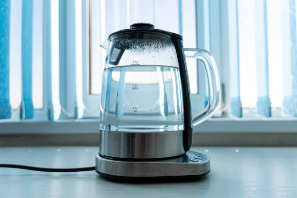 istock Pure water boils in an electric kettle on the table in kitchen 1453523624