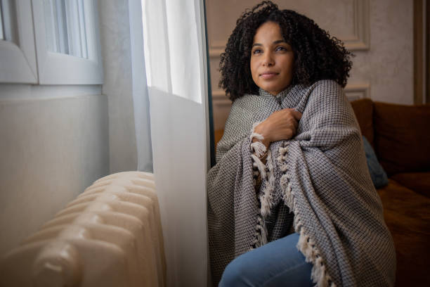 istock Woman feel cold in home with no heating 1453523693