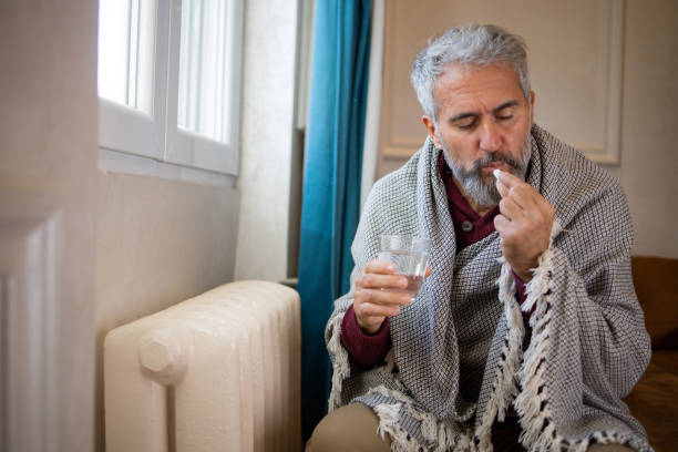 istock Senior man feel cold in home with no heating 1453523699
