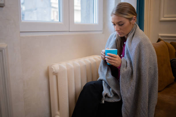 istock Woman feel cold in home with no heating 1453523716