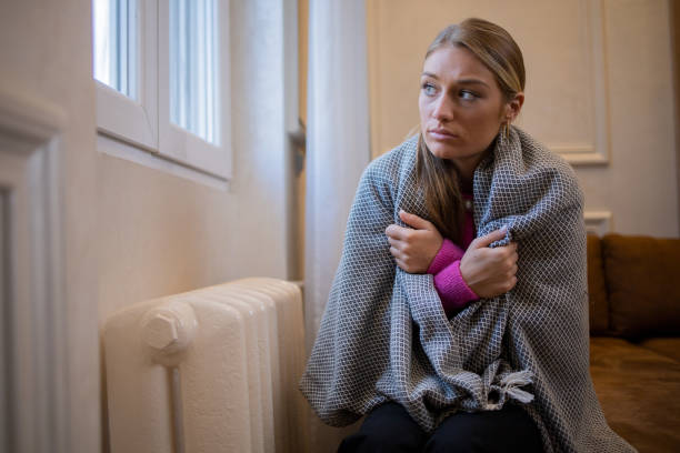 istock Woman feel cold in home with no heating 1453523719