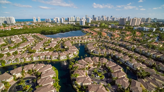 Aerial wide view of the skyline of Sunny Isle Beach from Aventura, over the Aventura Lakes, on a sunny spring day. Miami, Florida.