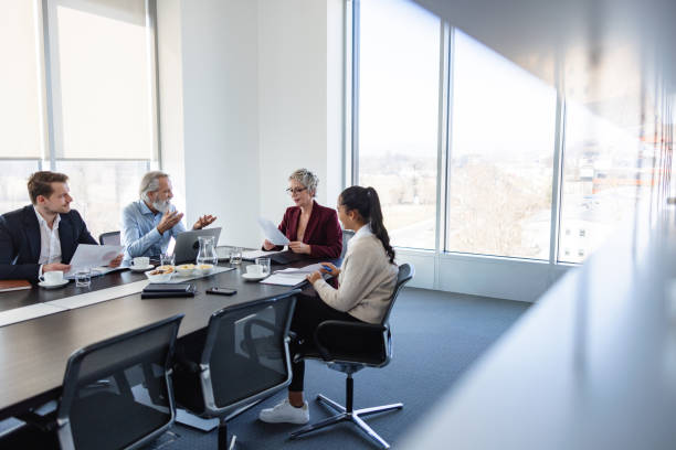 Female Manager Standing Addressing Colleagues At Office