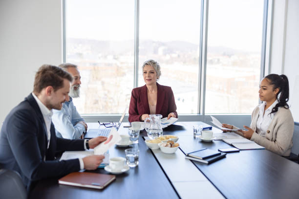istock Female Manager Standing Addressing Colleagues At Office 1453524981