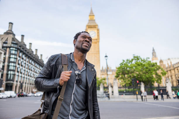 istock Black Man With Leather Jacket Waking In Front Of The Big Ben 1453525001