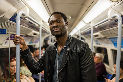 Mature Black Man In A Subway Train On His Way To Work