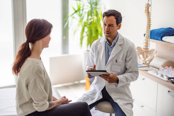 istock Handsome Male Doctor Using Wireless Technology At His Office 1453525019