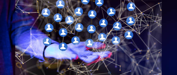 istock Illustrated network graphic with blue icons over a person's hand. Human resources concept 1453525599