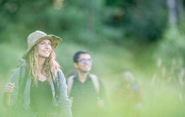istock Young Adults Hiking Through a Meadow 1453533327
