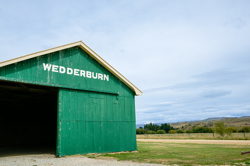 Central Otago New Zealand - March 2 2010; Wedderburn landmark old green railway shed with district name in white lettering.