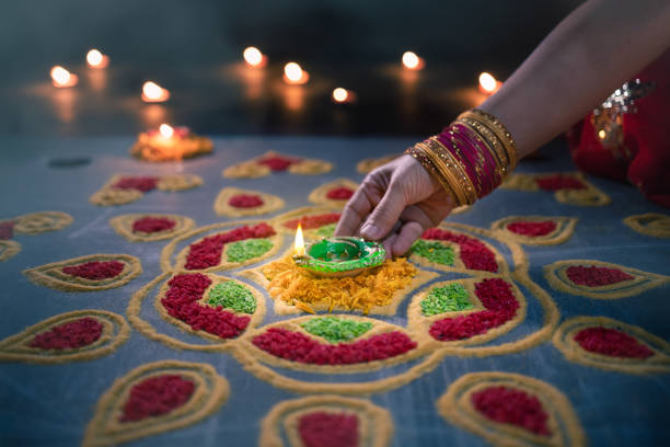 istock Happy Diwali - Diya lamps lit during diwali celebration 1453539083