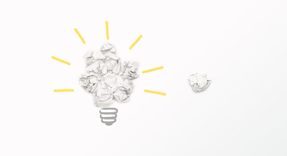 Try harder for better idea innovation result concept, light bulb shape from paper balls on light background