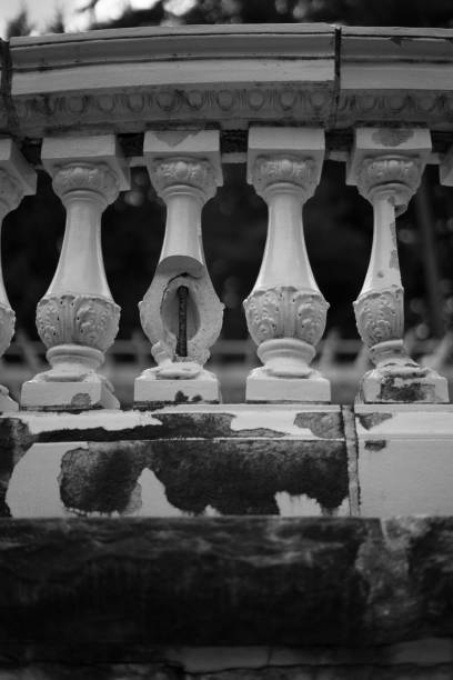 A grayscale shot of a balcony railing