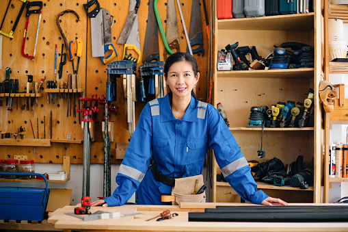 Woman in her workshop with a lot of different tools.
