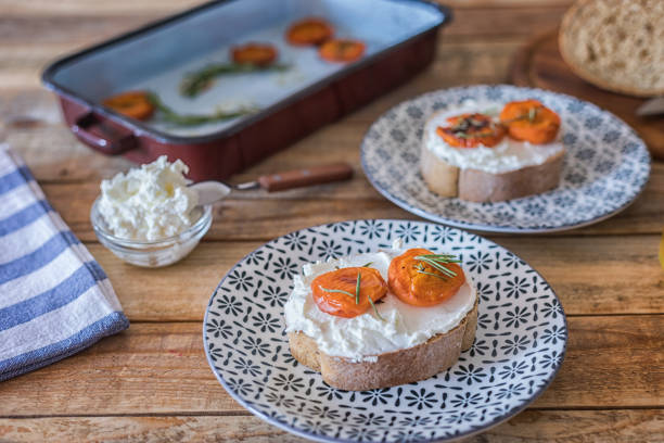 istock Bread slices with sweet cheese spread and baked apricot 1453557677