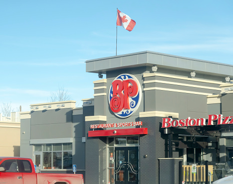 Calgary, Alberta, Canada. Dec 31, 2022. A horizontal view Boston Pizza restaurant location.