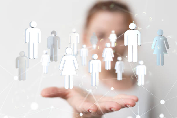 istock Illustrated network graphic with white icons over a person's hand during a presentation 1453568003