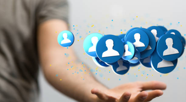 istock Illustrated network graphic with blue icons over a person's hand 1453568023