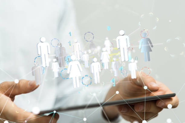 istock Network graphic with transparent icons with a person's hand holding a tablet from the background 1453568097