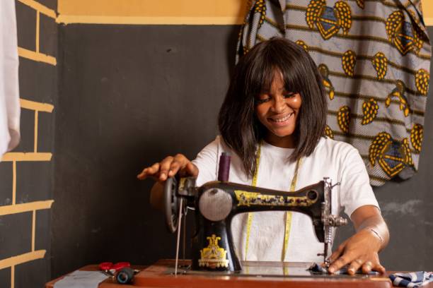 istock Nigerian tailor working in her shop with a sewing machine 1453568106