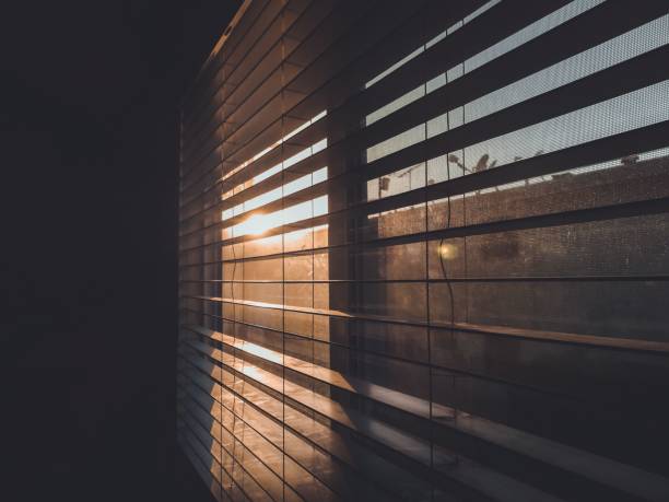 istock View of a bright sunset sky visible through window blinds 1453568366