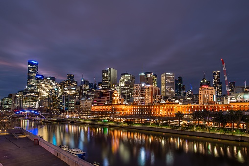 Melbourne CBD, Australia – August 17, 2022: The beautiful Yarra River reflecting the skyscrapers during nighttime, Melbourne