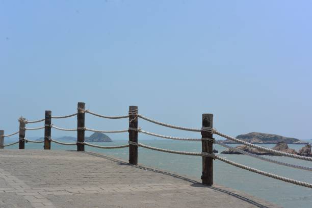 istock Empty pathway near the sea with a blue sky in the background 1453570962