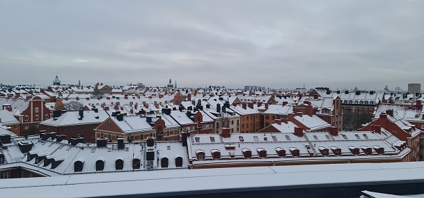 A panoramic shot of residential buildings covered in snow