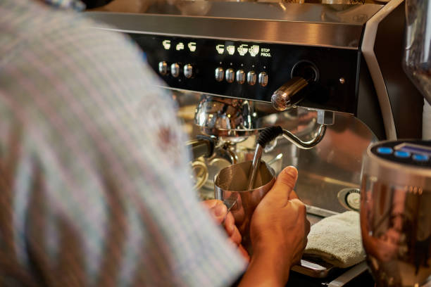 istock Close-up of barista's hands making coffee 1453573512