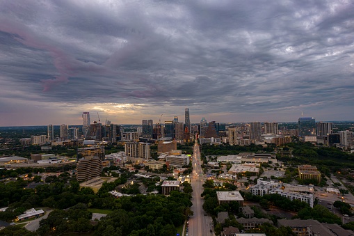 A drone shot of Austin cityscape under stormy sky in Texas