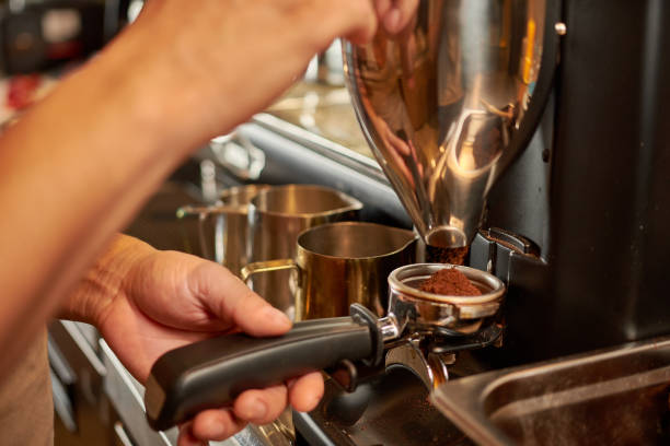 istock Close-up of barista's hands making coffee 1453573685