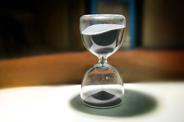 istock Sand running through the bulbs of an hourglass 1453574554