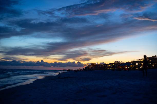 istock Silhouette of buildings in beach during sunset 1453575845