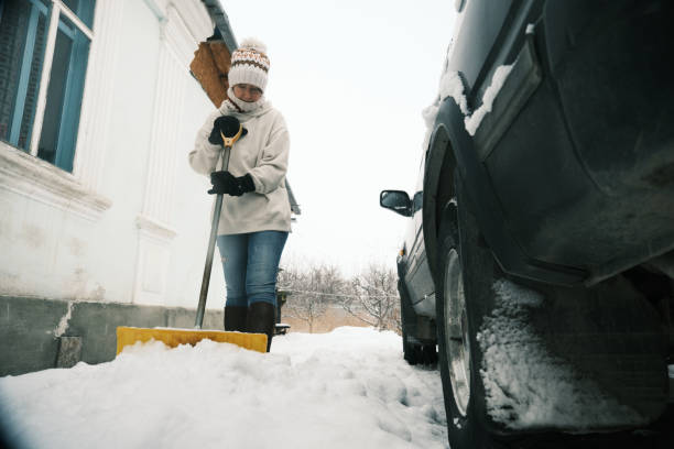 istock Woman is shoveling snow in the frontyard 1453577658