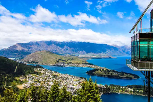 An aerial shot of Queenstown island in background of mountains in daylight