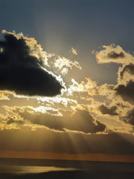 istock Scenic view of a half-dark cloudy sky saturated with clouds at sunset with a glimpse of sunlight 1453579957
