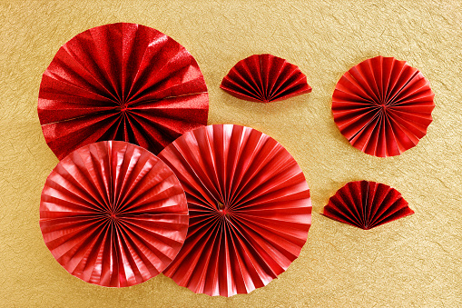 Chinese new year festival decoration with red Chinese folded fans on golden background. Celebrate Happy Chinese new year background concept. Top view.
