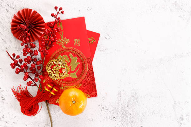 Chinese new year festival decorations with red bags, oranges and red Chinese folded fans on white marble table background. Chinese new year festival decorations with red bags, oranges and red Chinese folded fans on white marble table background. Celebrate Happy Chinese new year background concept. Top view. mandarin chinese new year stock pictures, royalty-free photos & images