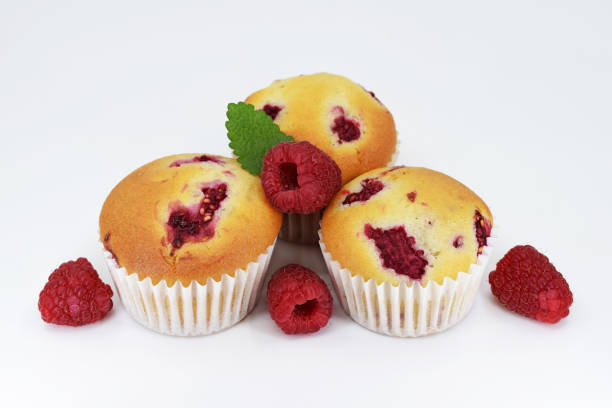 istock Muffins with raspberries on white background with fresh fruits 1453585347